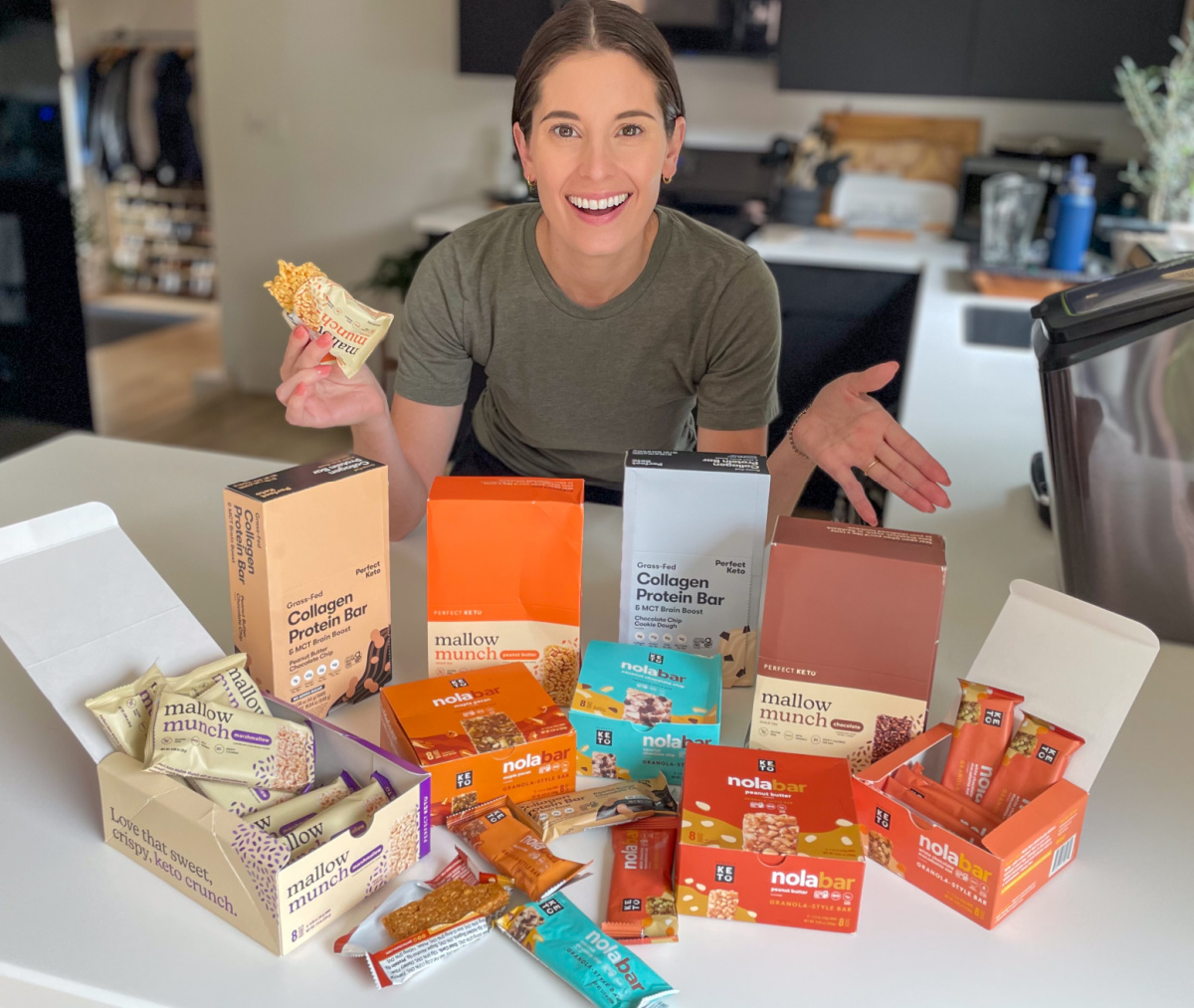 Woman with different varieties of Perfect Keto Bars