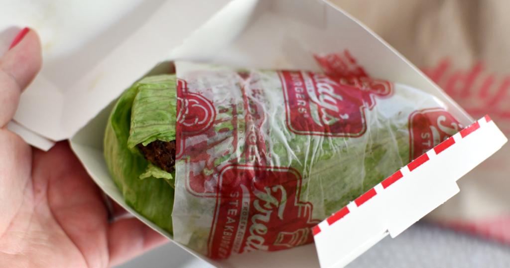 holding Freddy's lettuce wrapped sandwich 