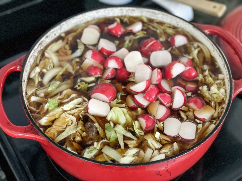 adding radishes to a dutch oven
