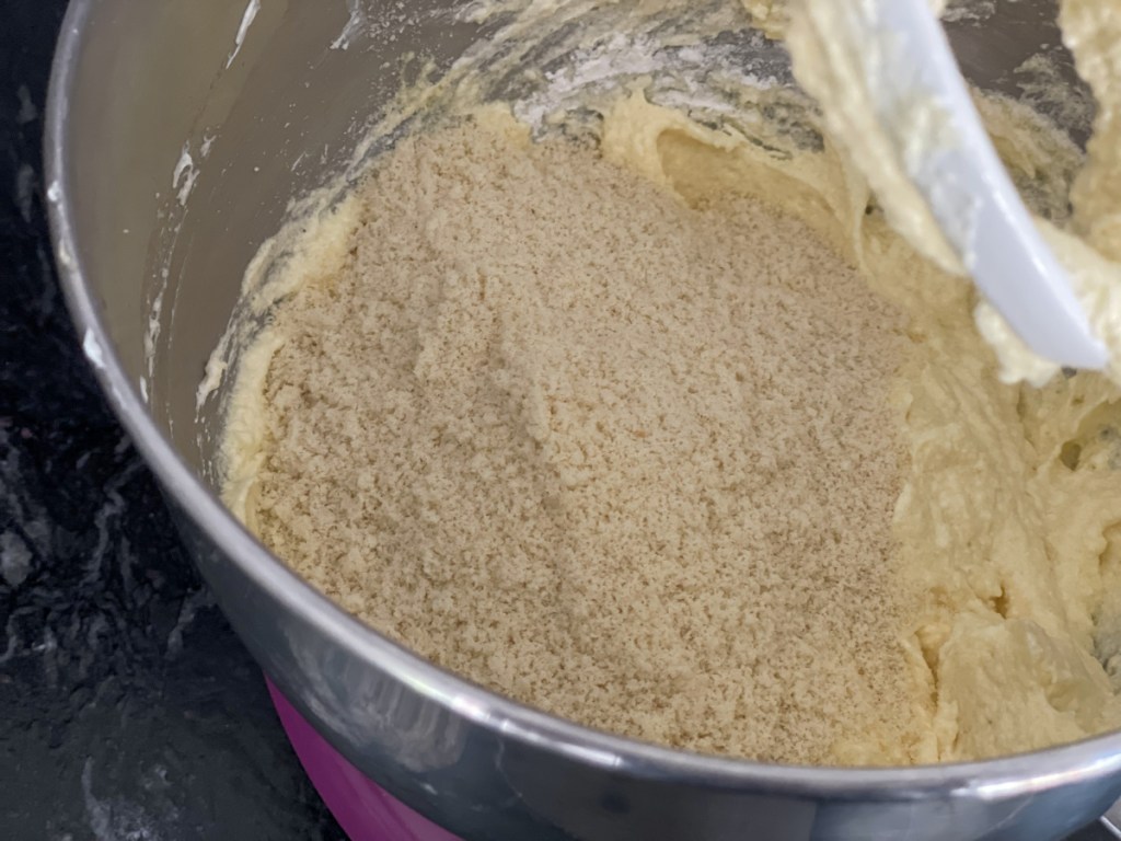 adding almond flour to mixing bowl