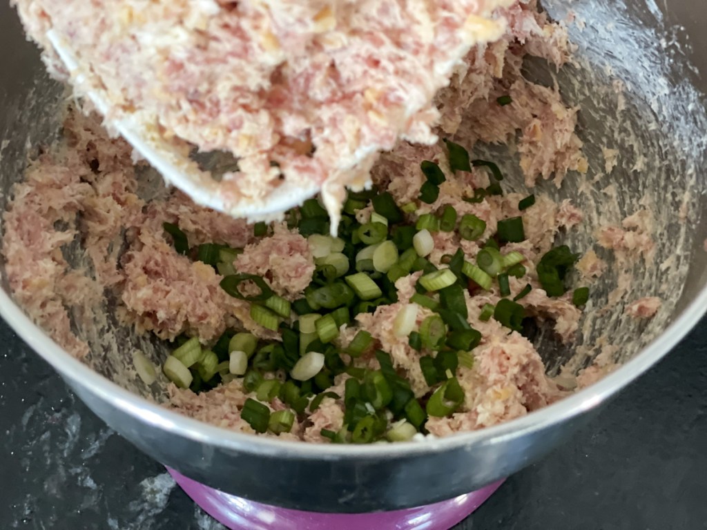 green onions and sausage in a bowl