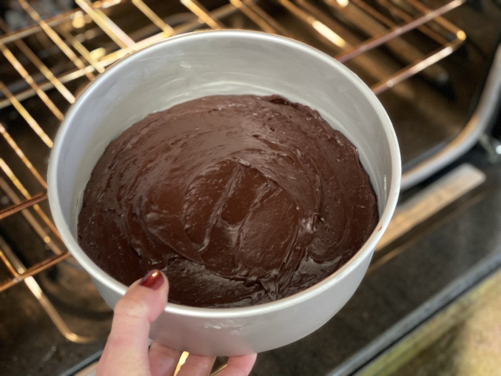 putting keto flourless chocolate cake in the oven