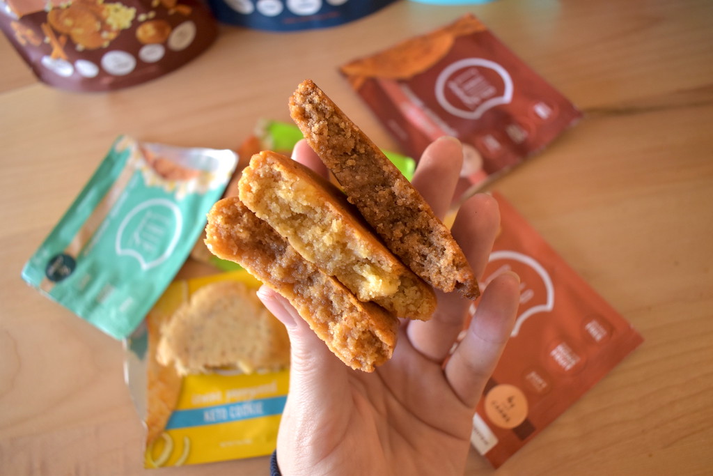 holding 3 Chip Monk keto cookies 
