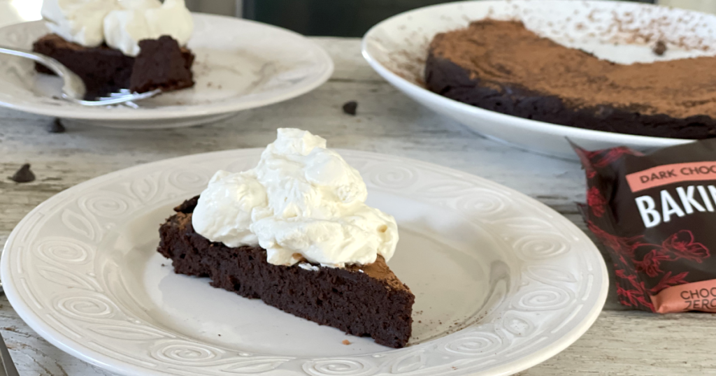 flourless chocolate cake with keto whipped cream recipe on it