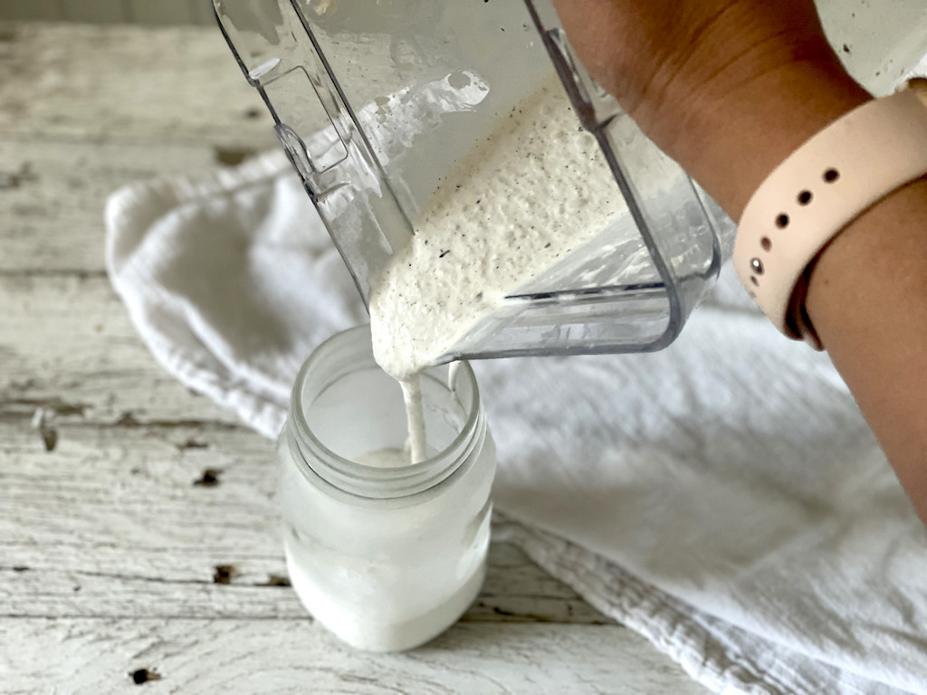 pouring keto milkshake into mason jar 