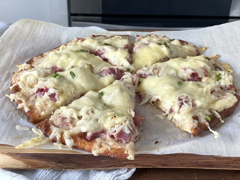 keto Reuben pizza sliced up on platter 