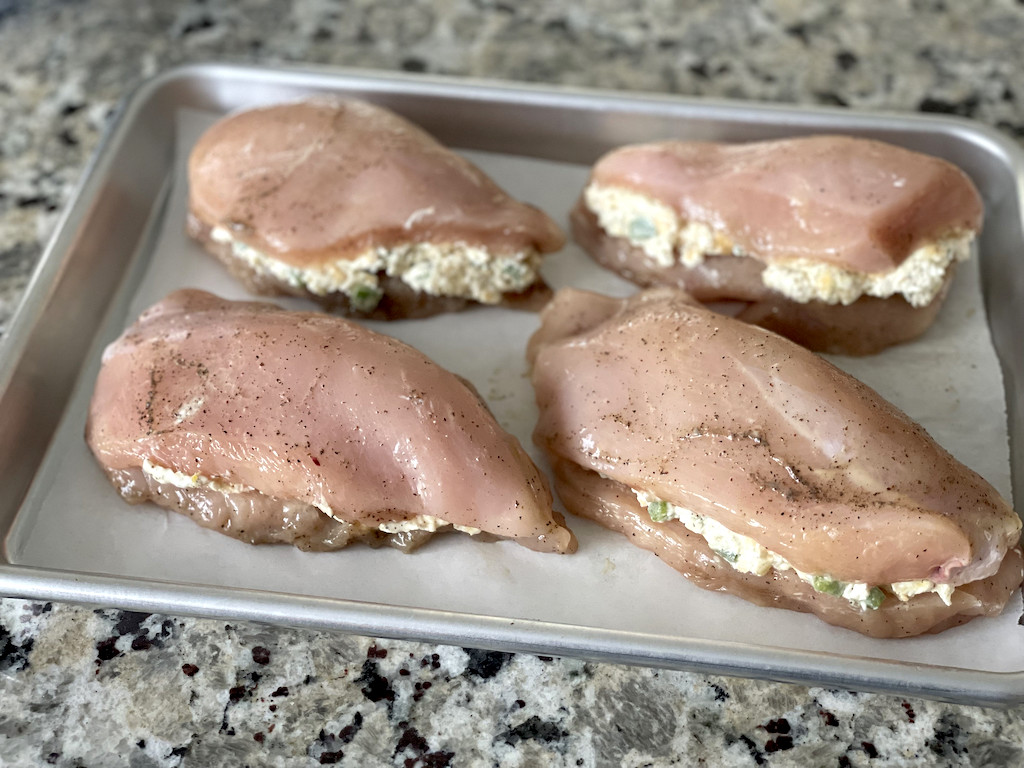 stuffed chicken breasts with cream cheese on pan 
