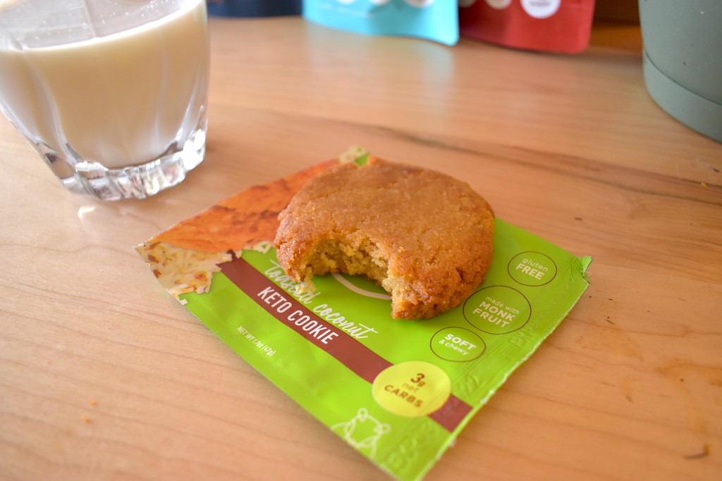toasted coconut keto cookie next to glass of almond milk 