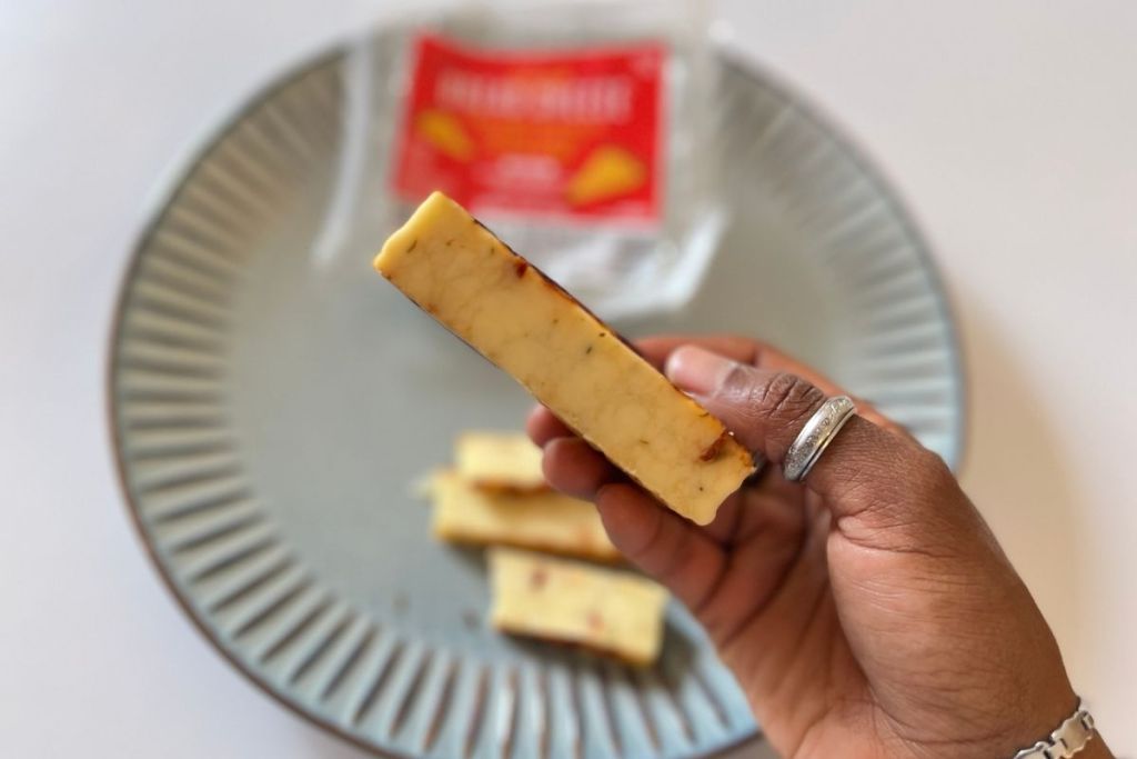 holding a slice of bread cheese