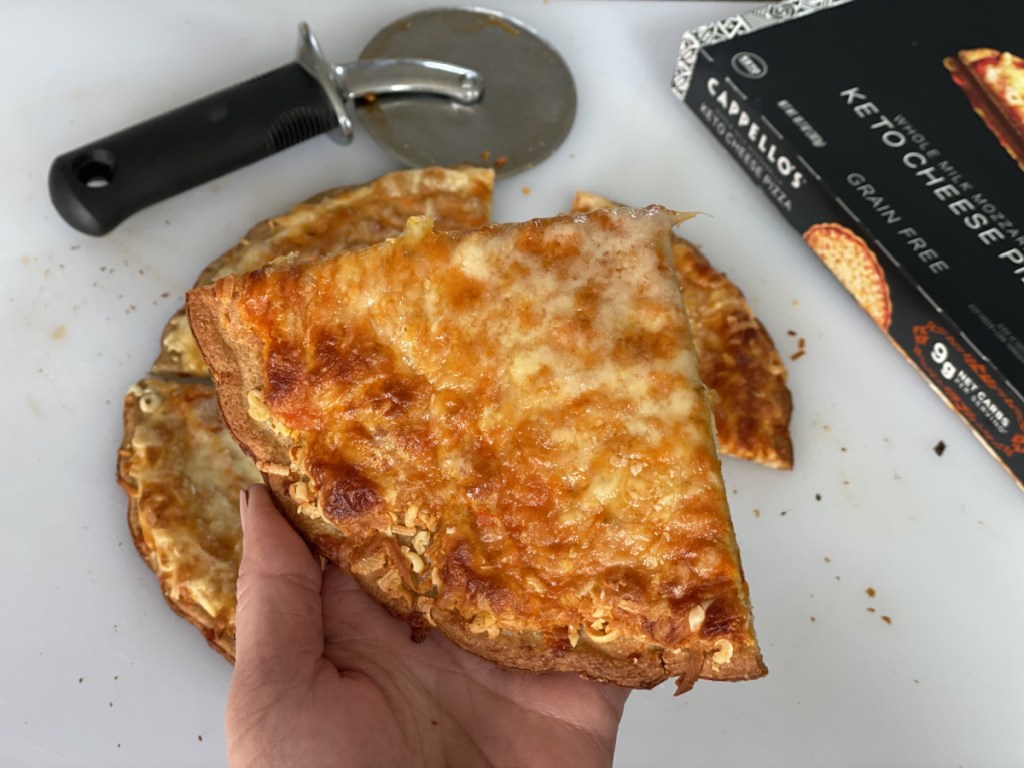 Cappellos frozen keto pizza holding a slice