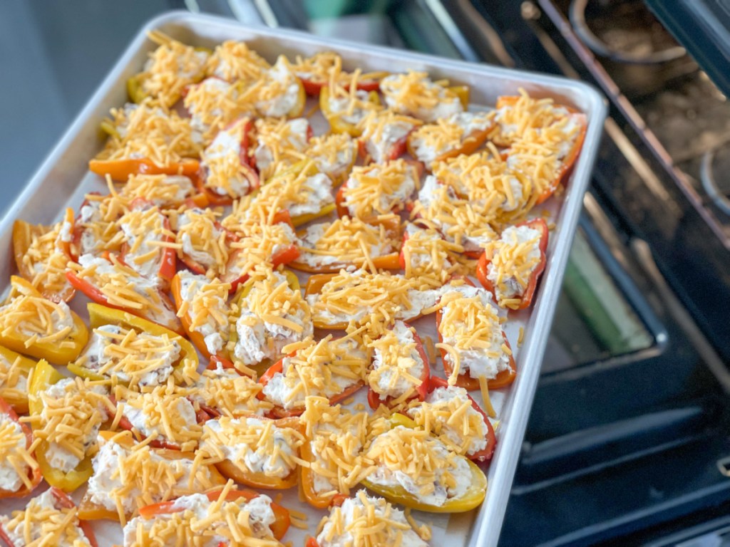 cream cheese stuffed mini peppers going into the oven