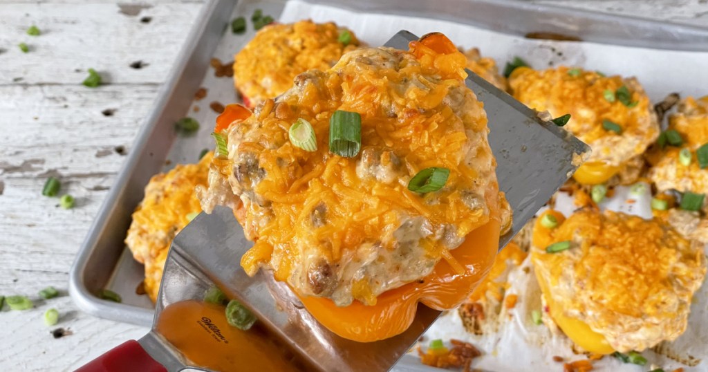 Cream cheese and chicken stuffed bell peppers on a spatula 