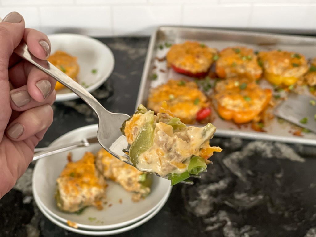 bite on a fork of cream cheese and chicken stuffed bell peppers
