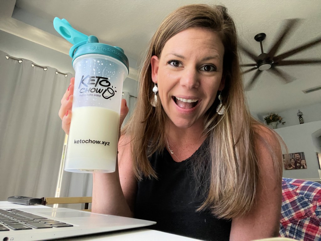 Woman holding up a low carb protein supplement