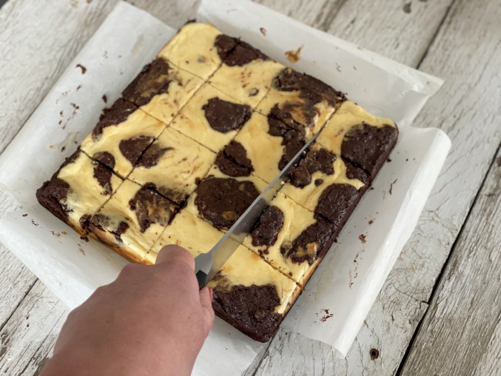 slicing keto cream cheese brownie