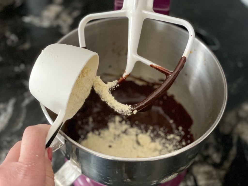 adding almond flour to melted chocolate mixture