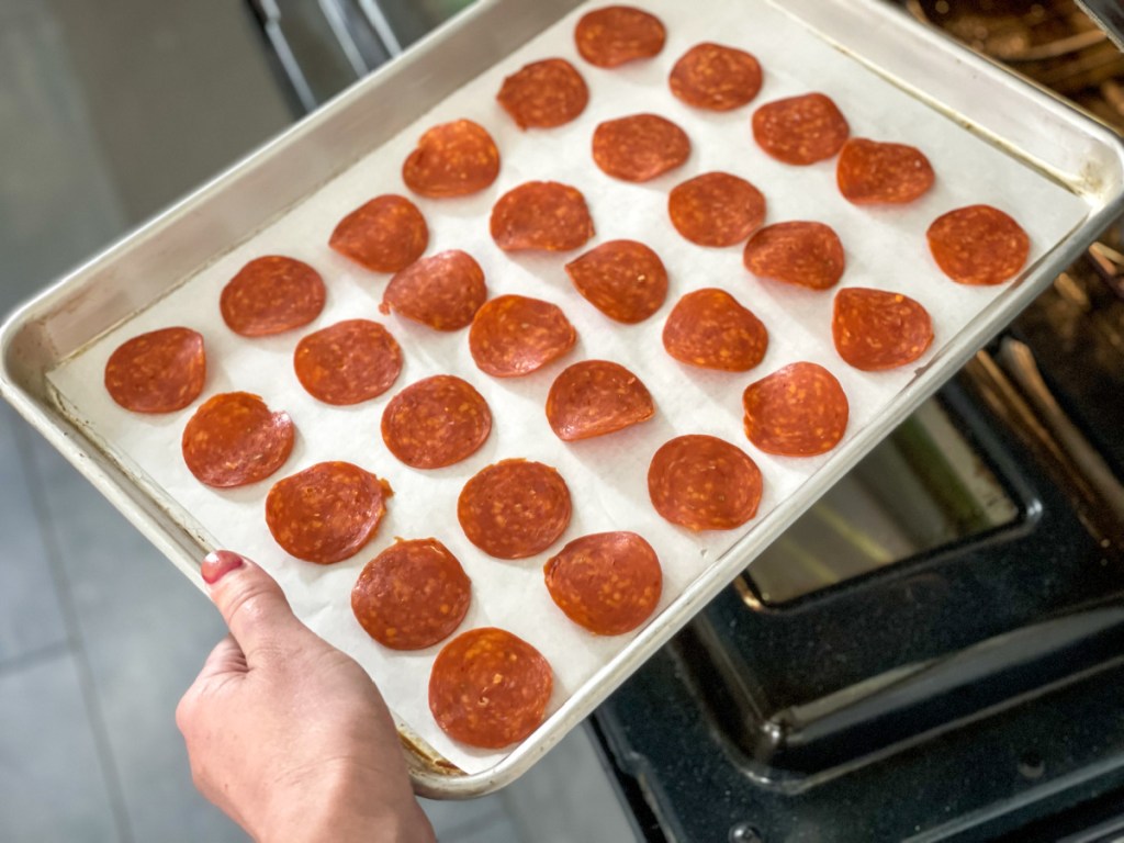 putting pepperoni slices in the oven