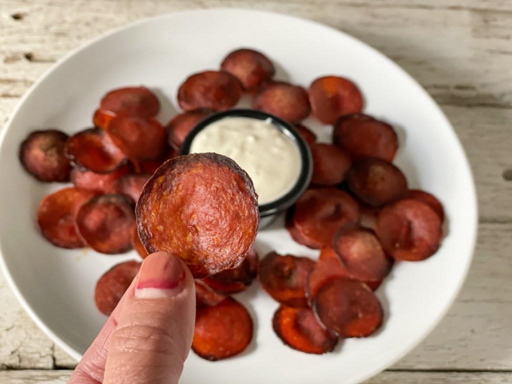 holding a baked pepperoni chip