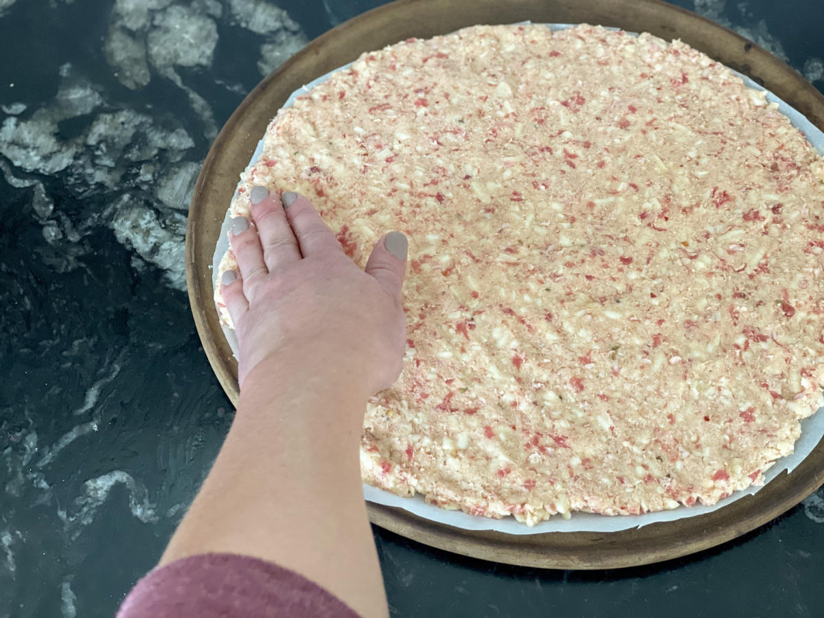 flattening out crust with hand