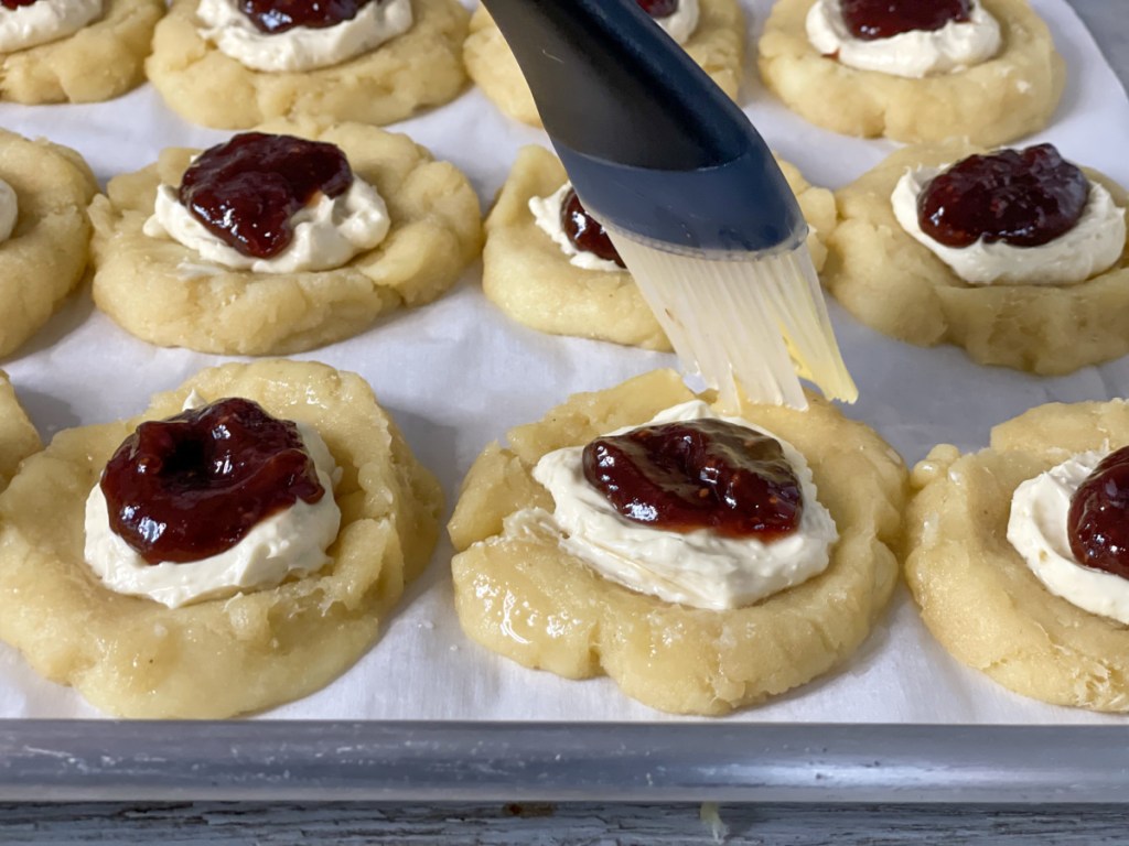 putting egg wash on keto strawberry cream cheese danishes 