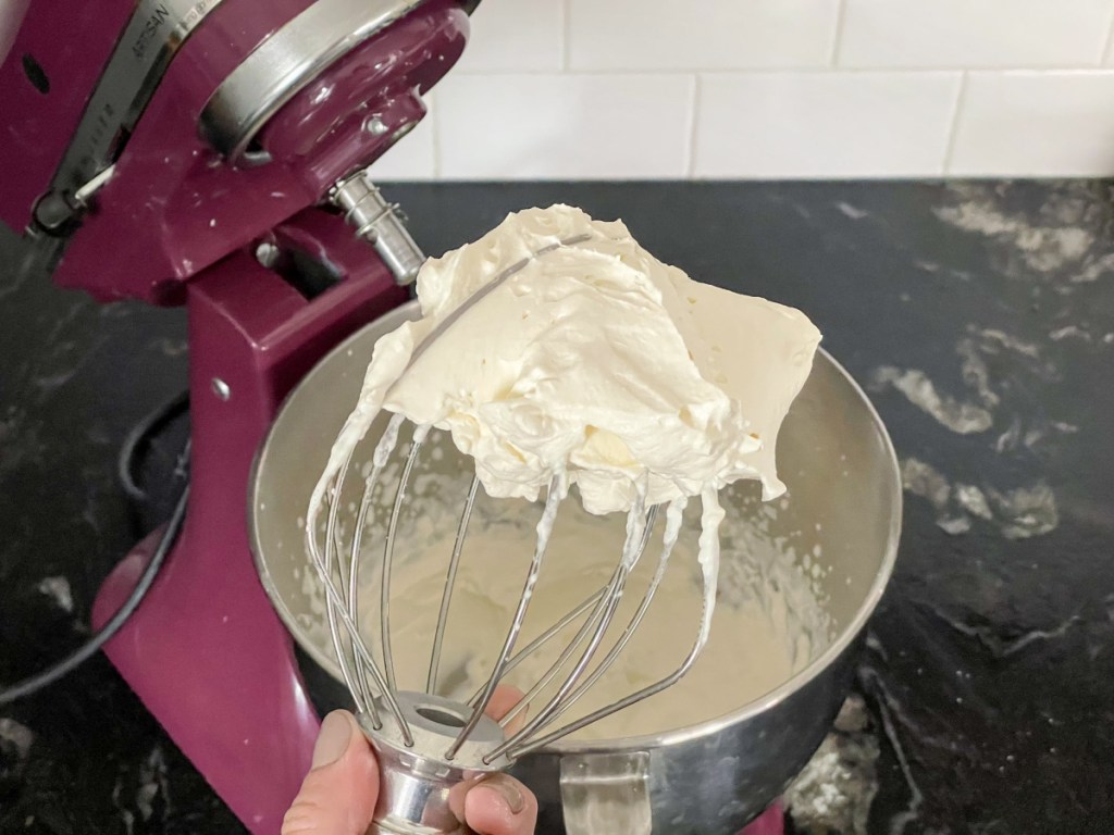 holding a whisk with keto whipped cream recipe