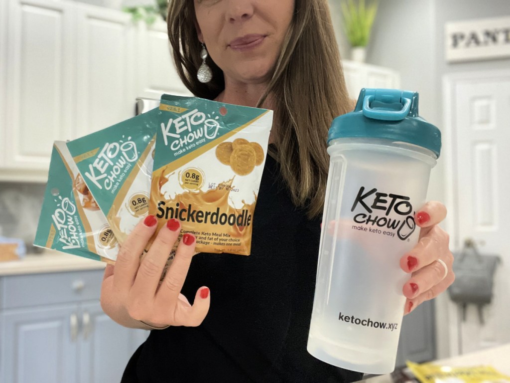 Woman holding up meal replacement products