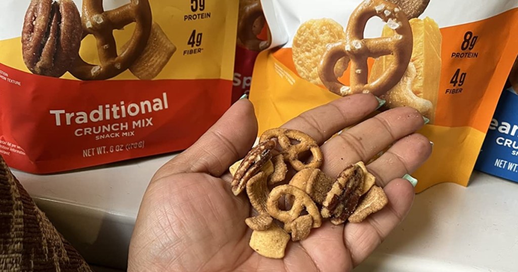 holding handful of keto snack mix