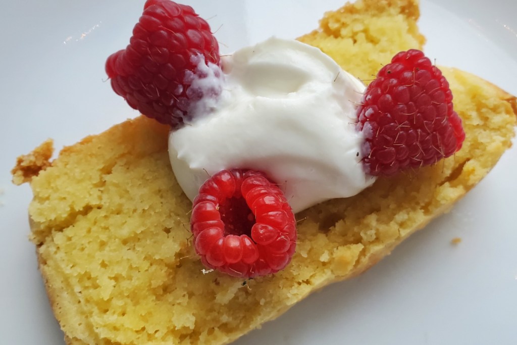 keto lemon pound cake slice with raspberries