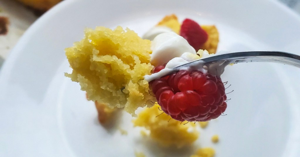 piece of keto pound cake, whipped cream, and raspberries