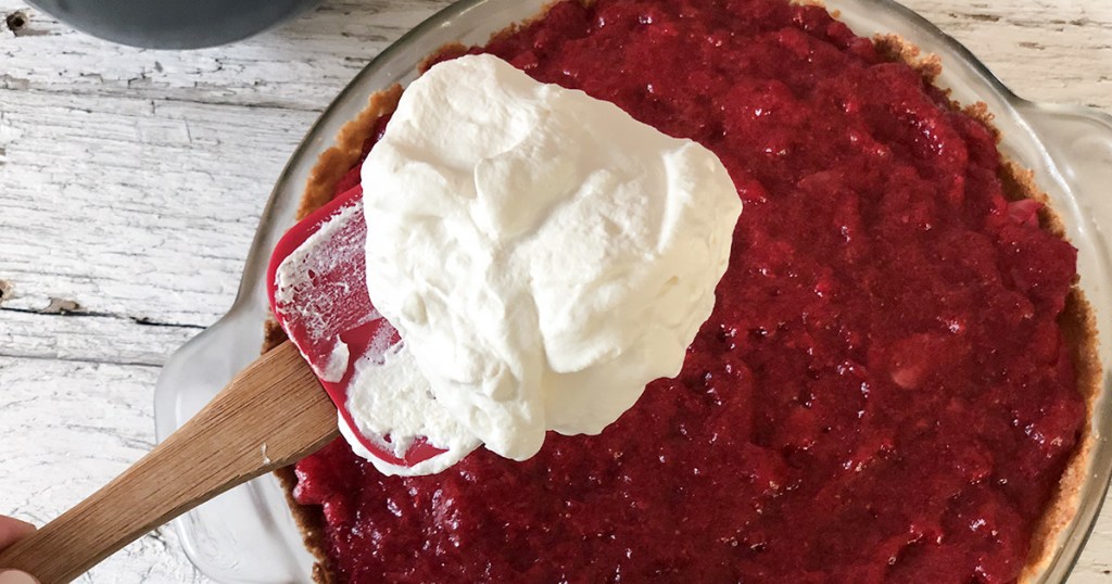 keto whipped cream on spatula for strawberry pie