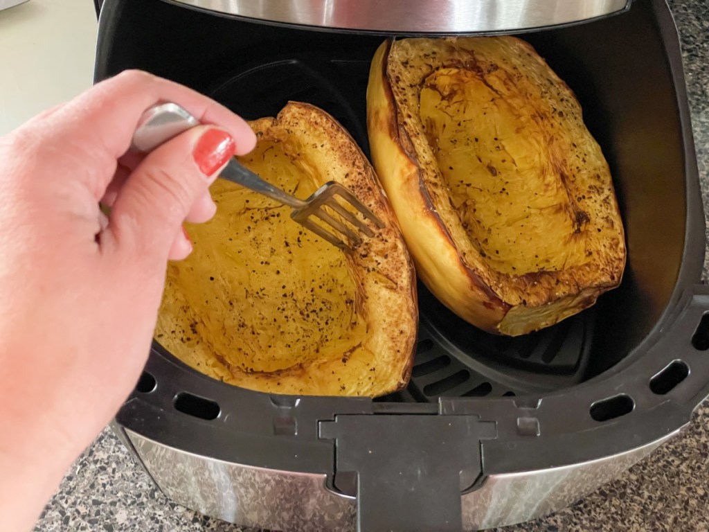 poking spaghetti squash with a fork