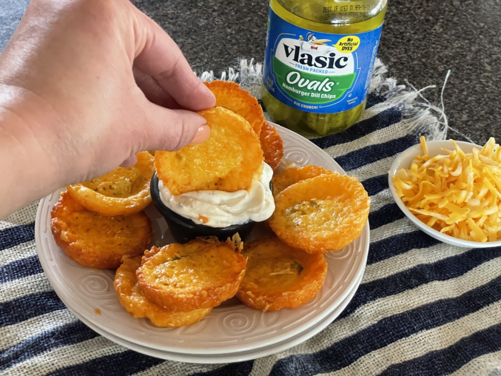 dipping cheese pickle chips in ranch 