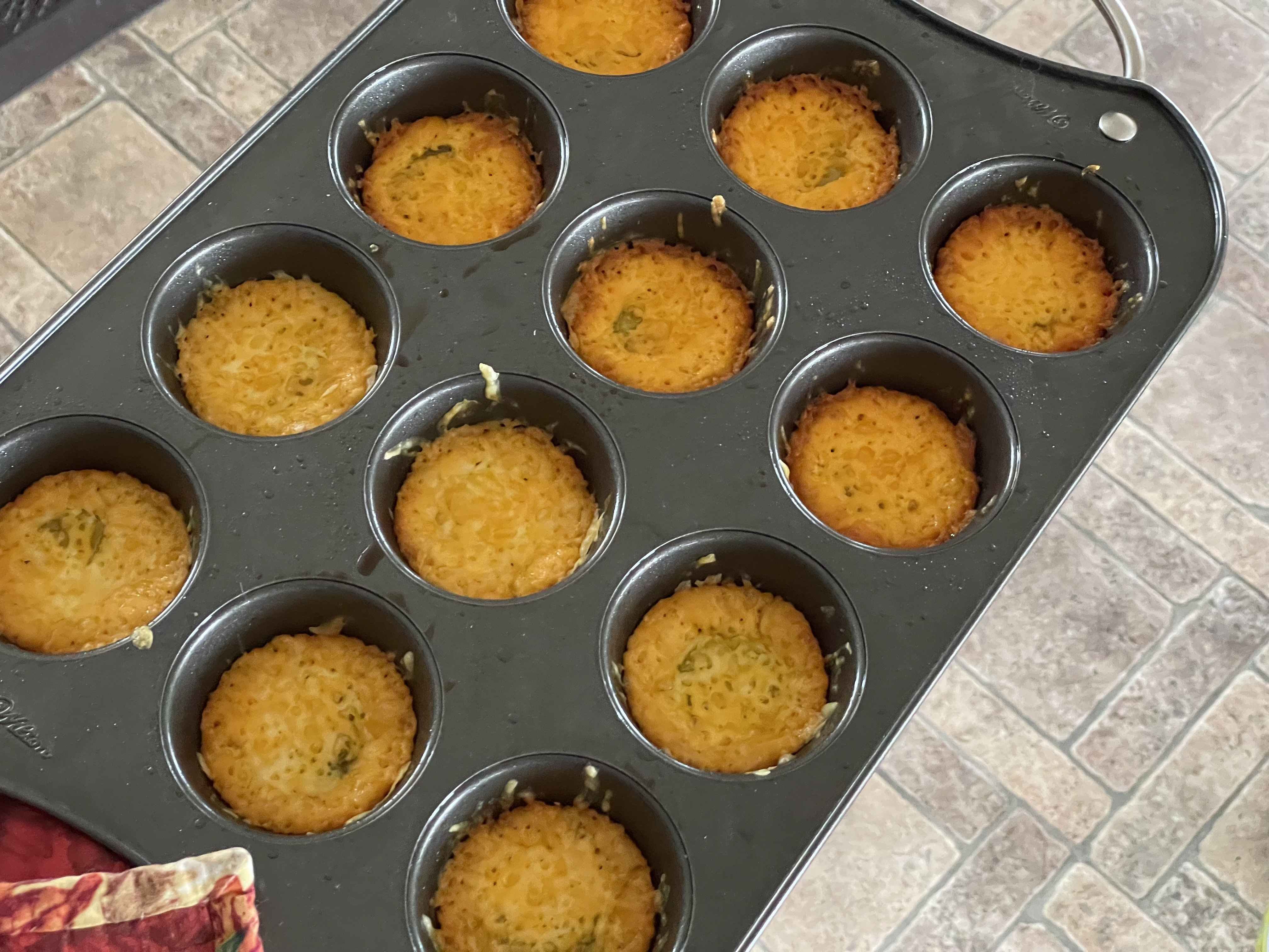 muffin pan with baked cheese pickle chips 