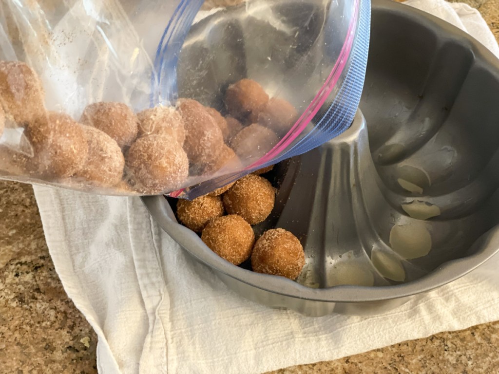 pouring dough balls into bundt pan