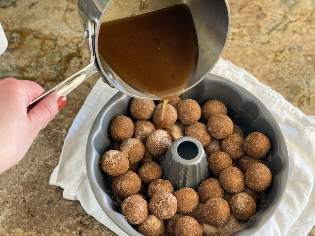 adding sticky sauce to dairy-free monkey bread dough balls 