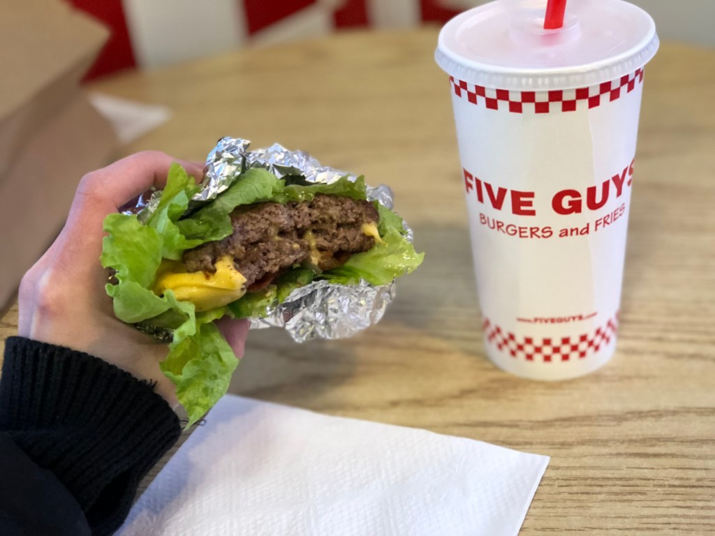 Person holding a keto burger from Five Guys