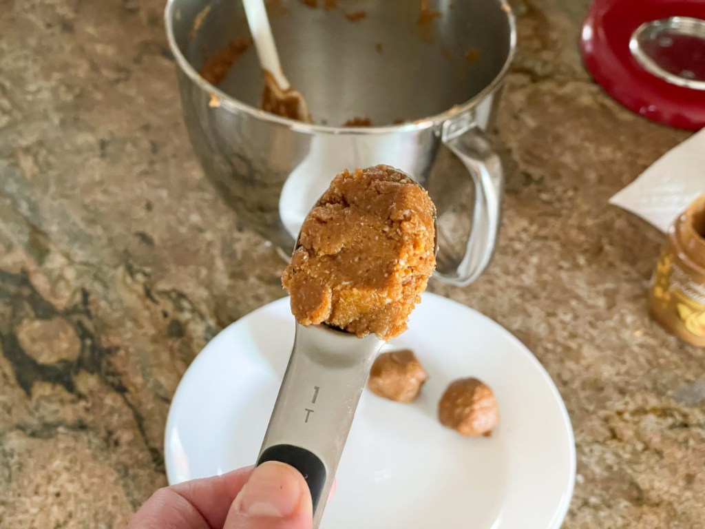 cookie dough in a tablespoon measuring spoon