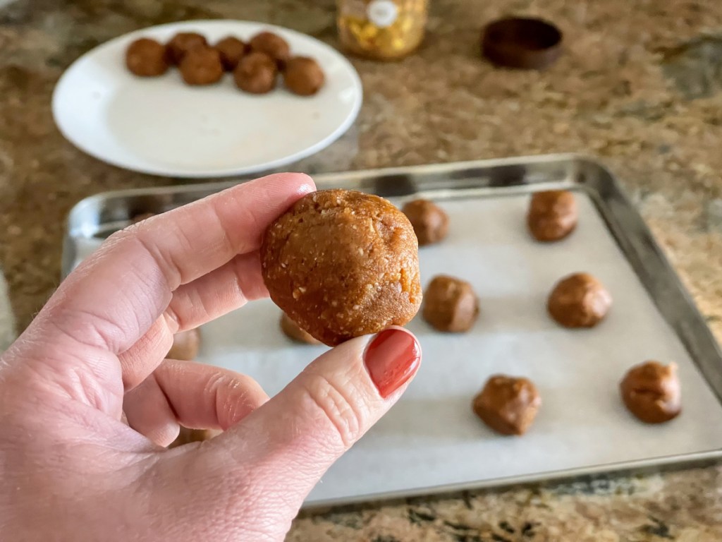 putting cookie butter cookie dough on cookie sheet 