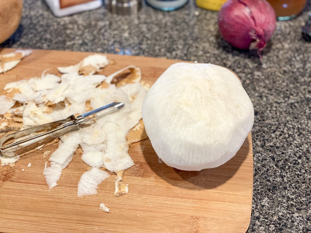 peeled jicama on a cutting board 