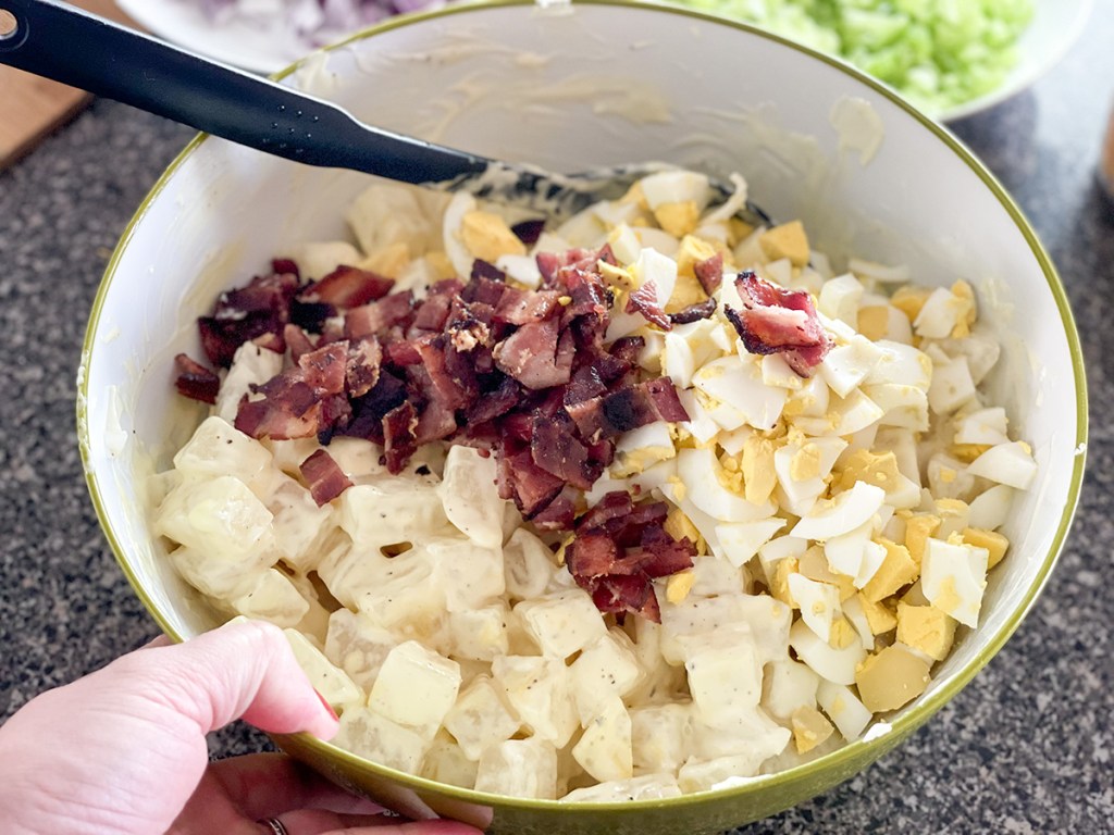 adding bacon and hard boiled eggs to cooked jicama 