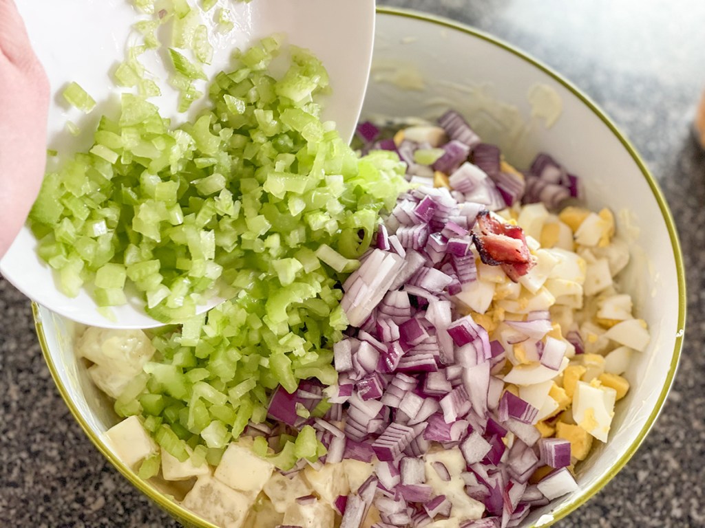 adding chopped onion and celery to cooked jicama 
