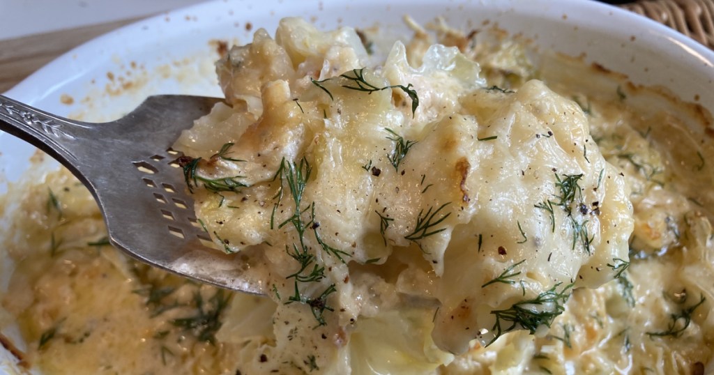 serving a scoop of scalloped cabbage