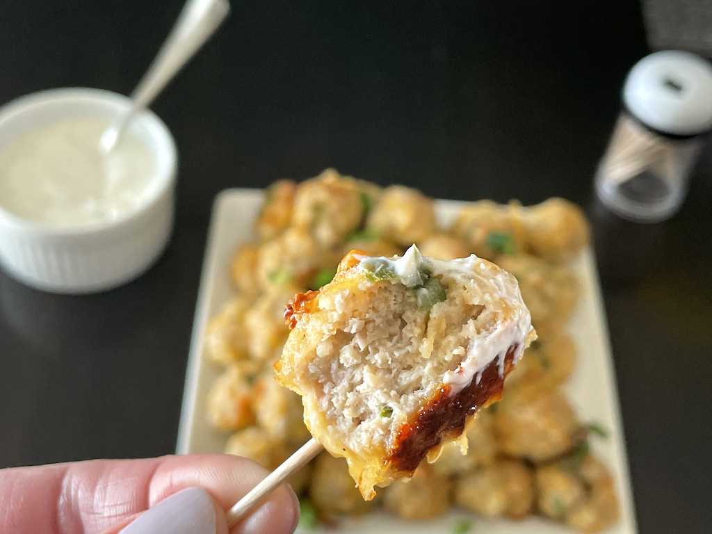 taking bite out of sausage cream cheese ball 