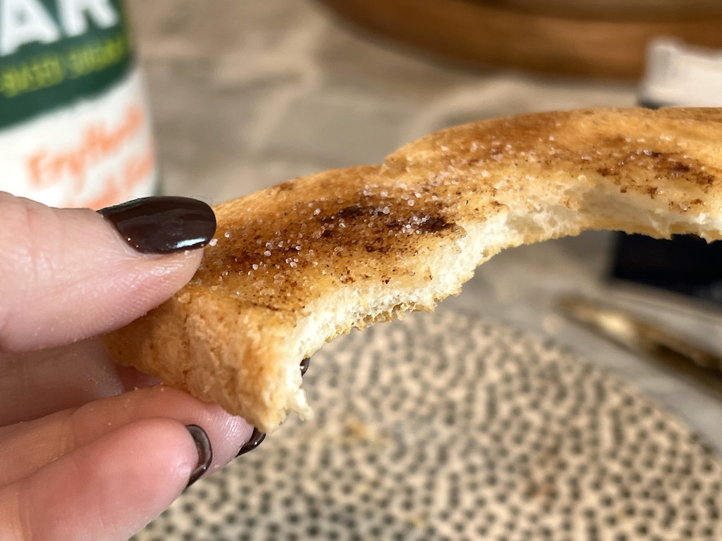 holding slice of cinnamon sugar toast
