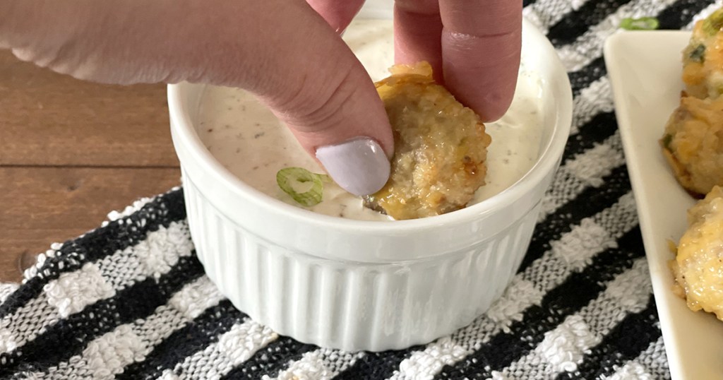 dipping keto cream cheese sausage balls in ranch