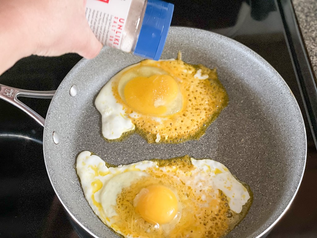 salting fried eggs with cheese