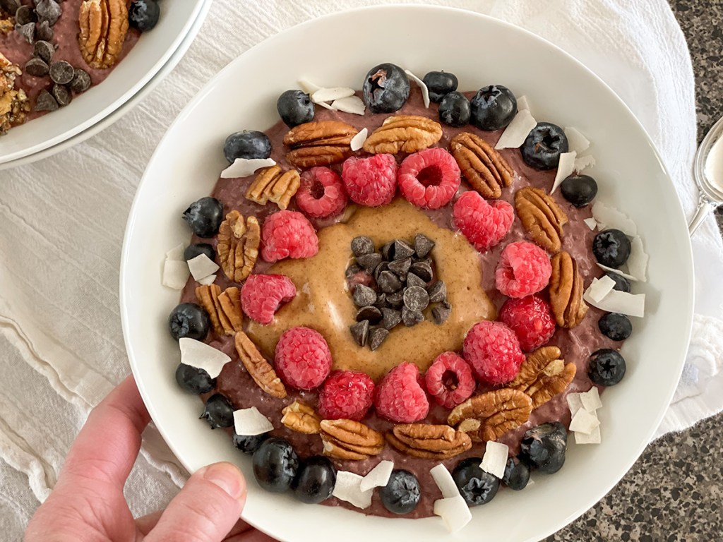 holding a keto acai bowl