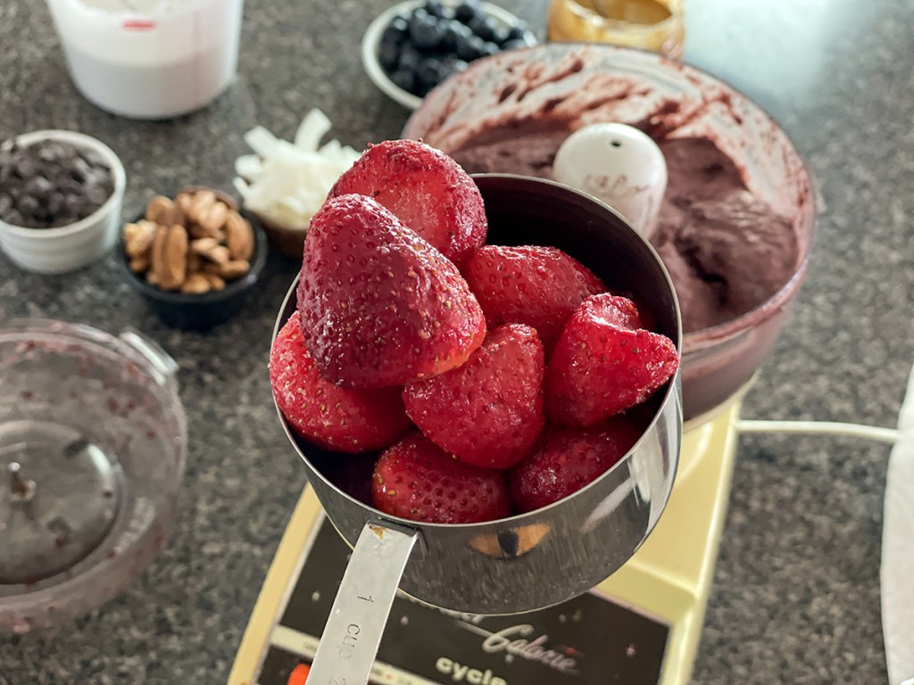 measuring cup of frozen strawberries