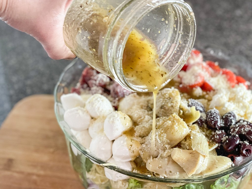 adding dressing to salad 