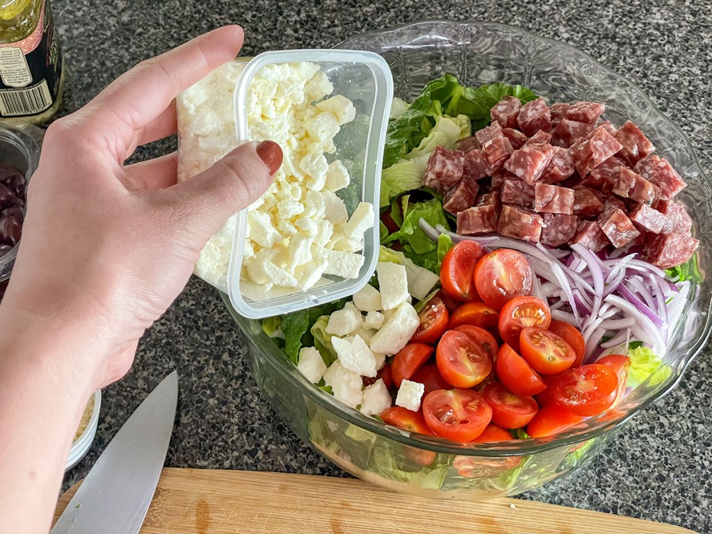 adding feta cheese to a salad